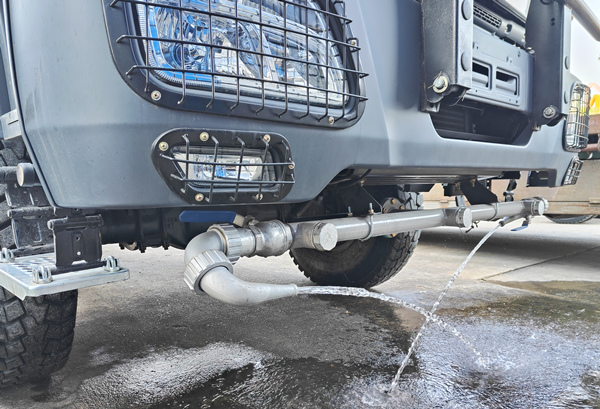 Front water spraying nozzles